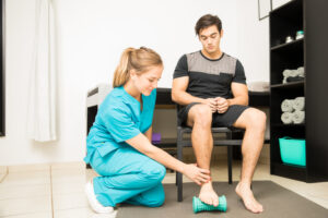 Physiotherapist Treating Plantar Fasciitis In Athlete